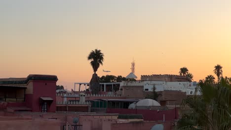 Airplane-flying-over-Marrakesh-city-in-Morocco-in-Africa-at-sunset