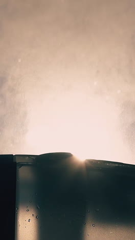 cu, slow motion, low angle shot: powerful air ionizer emits steam cloud to humidify atmosphere near window extreme closeup