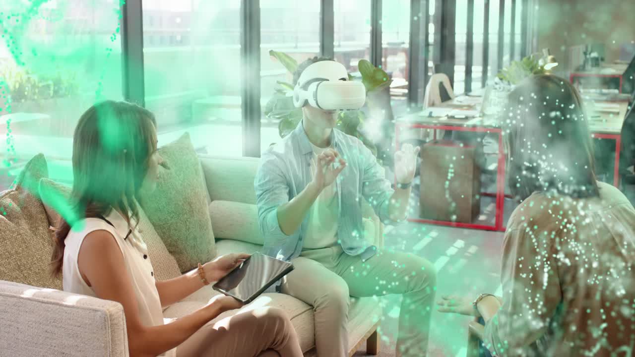 Team, right woman tapping tablet spawning VR particles as man pinching VR models for tech demo
