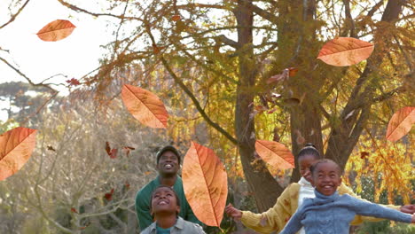 animation of autumn leaves falling over happy african american family in park