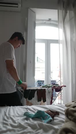 person doing laundry in a bedroom
