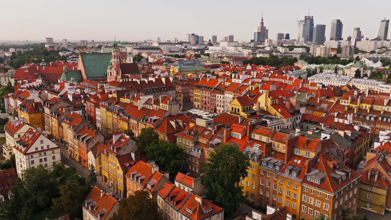 Drone view of Warsaw historic Old Town rooftops with city skyline background