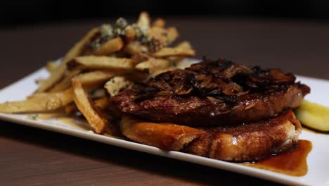 simple dish of beef steak alongside strips of deep-fried potato