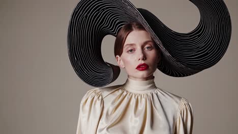 studio portrait featuring a fashion model wearing a striking, oversized black hat paired with a flowing white silk blouse, exuding a unique and stylish aesthetic