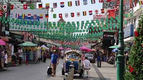 pedestrians and vendors on a decorated urban street