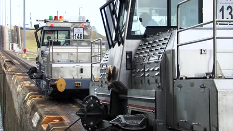 Locomotives-towing-the-ship-in-tandem-at-Gatun-Locks,-Panama-Canal