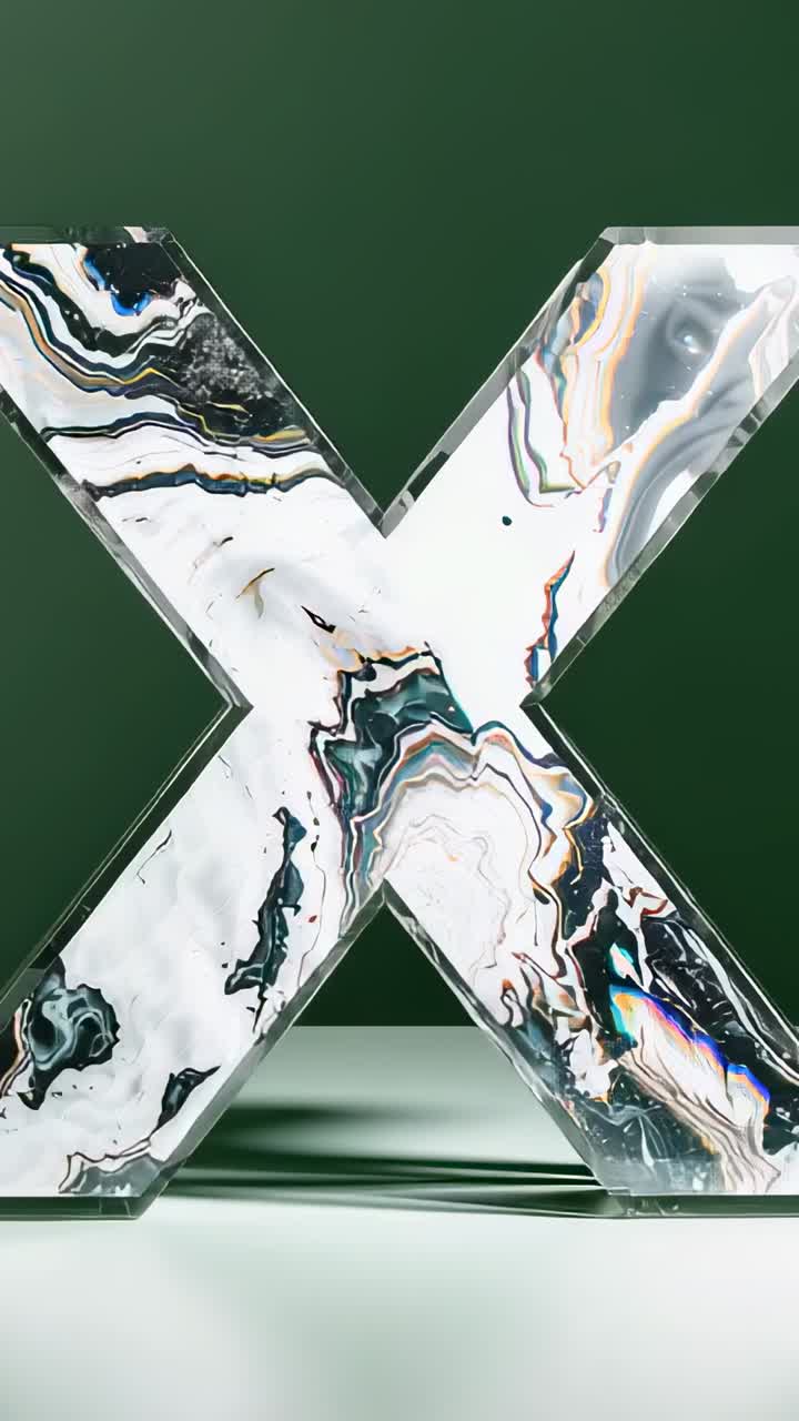 Vertical video: Sweeping lighting illuminating marbled crystal X in studio, hue deepening