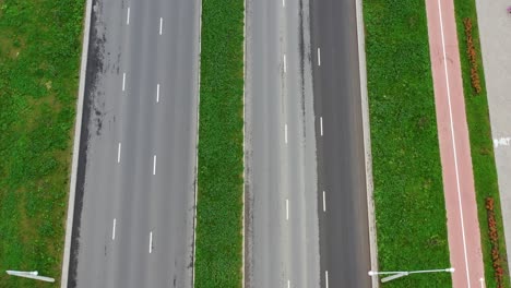 aerial top-down view of empty divided highway with green median