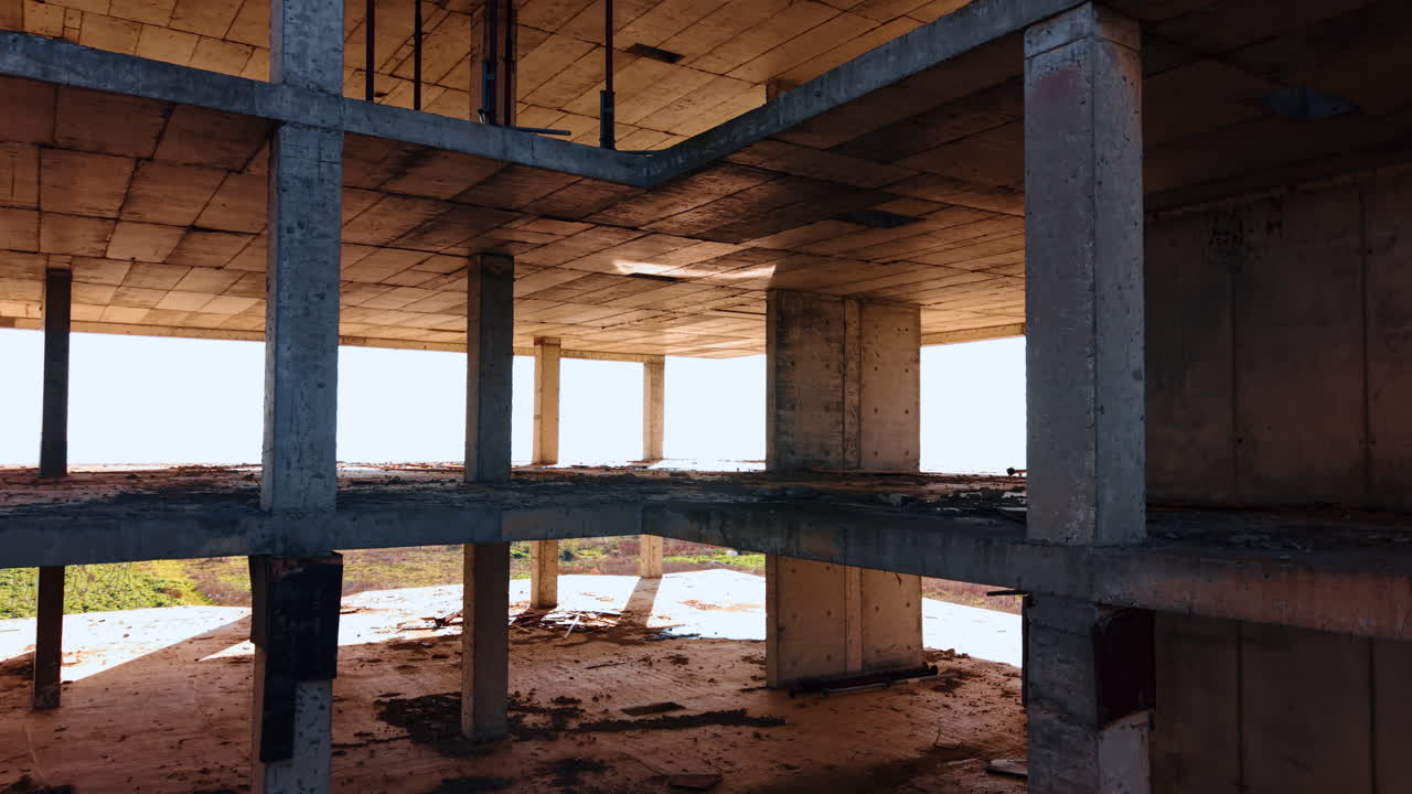 Floors of the unfinished structure with some rubbish on. Building construction at the seashore