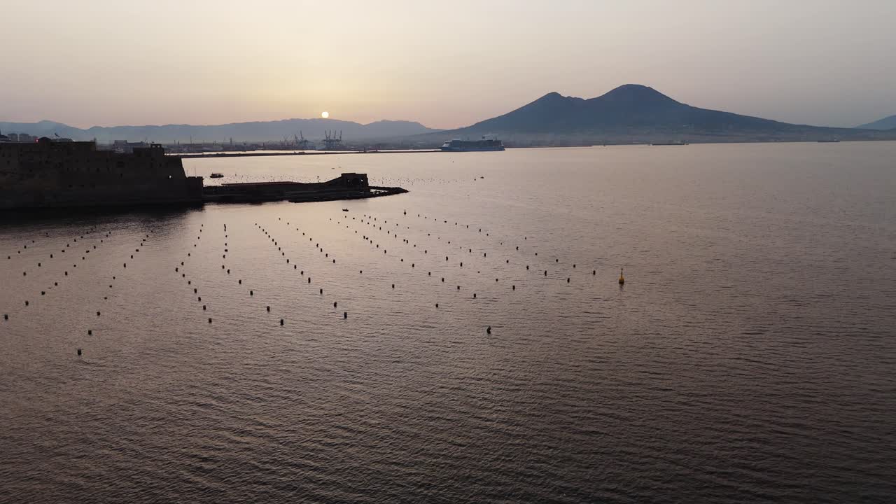drone fly above gulf of Naples sea bay revealing Vesuvio Mount Volcano at sunrise