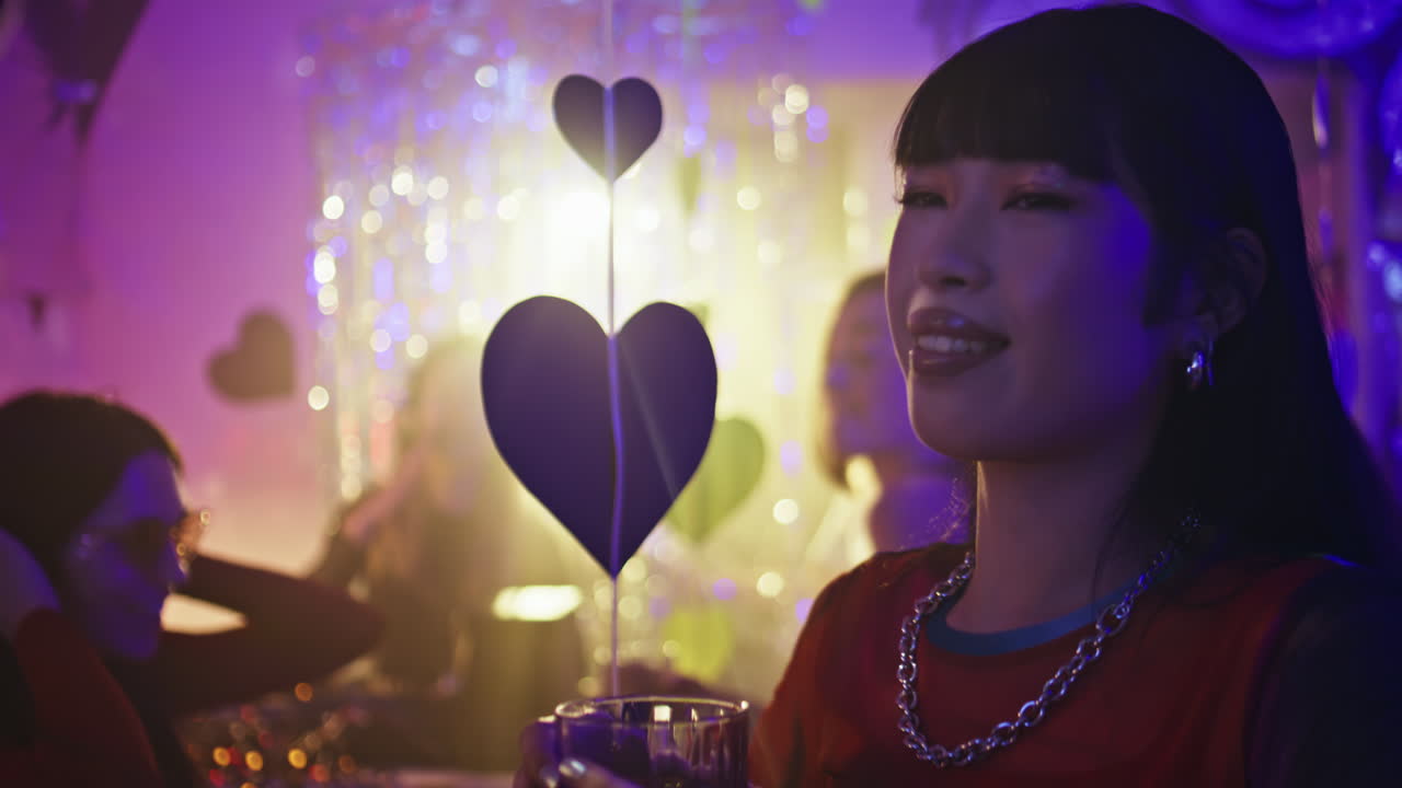 Party woman talking friend in club illuminated by neon light closeup. Nightlife