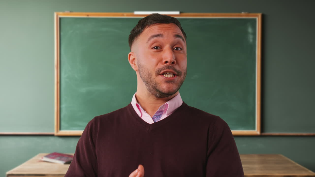 Close Up Shot Of Mature Male Teacher In Classroom Standing In Front Of Board Teaching Lesson 2