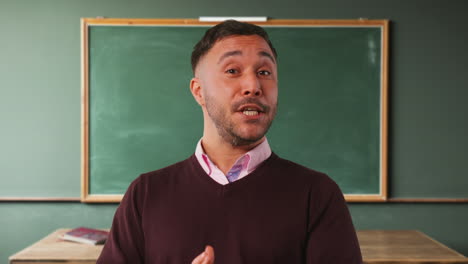 Close-Up-Shot-Of-Mature-Male-Teacher-In-Classroom-Standing-In-Front-Of-Board-Teaching-Lesson-2