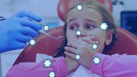 animación de redes de conexiones con iconos sobre la niña en la silla del dentista