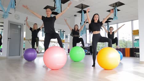 women exercising with exercise balls in a fitness studio