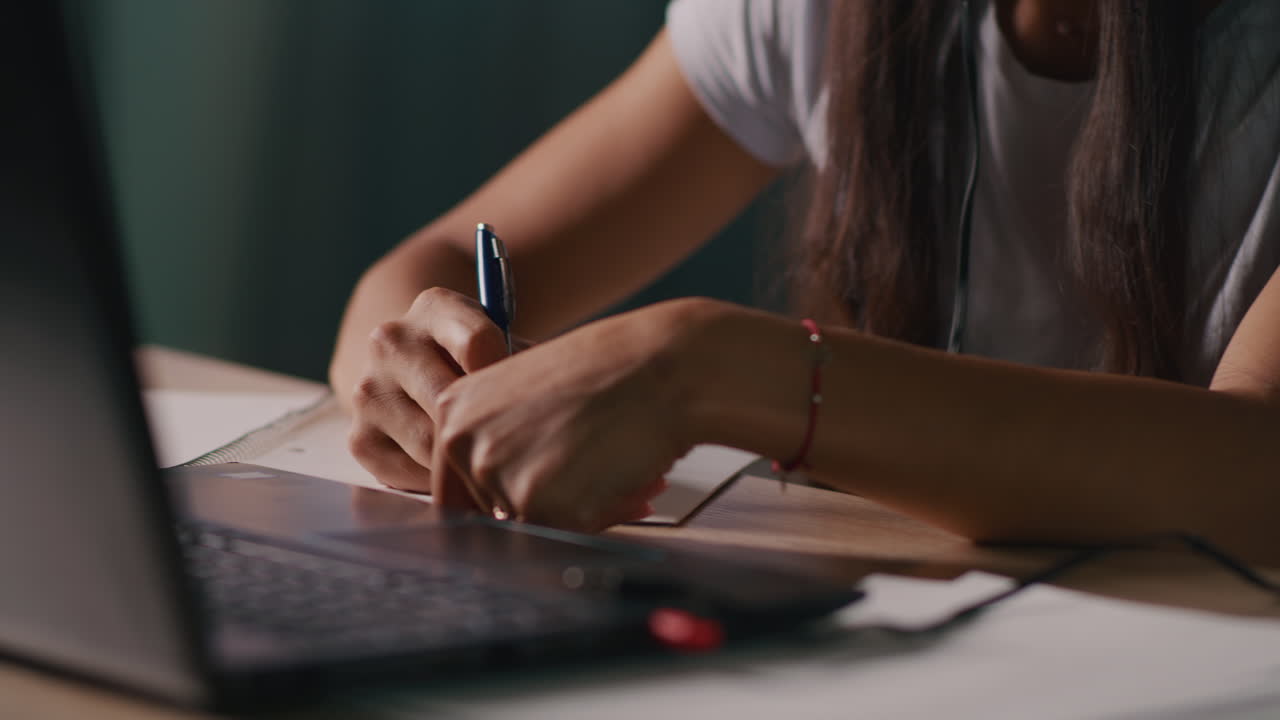 Woman Taking Notes During an Online Class