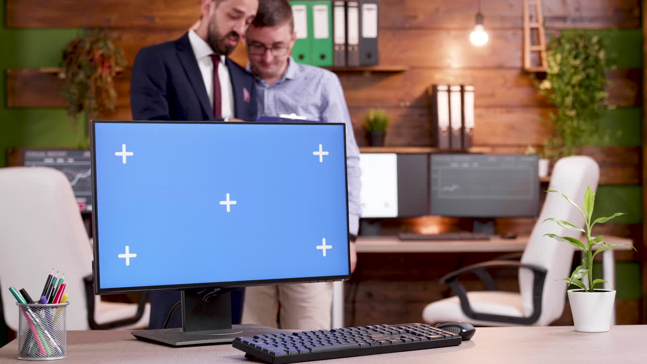 Office scene with computer and two men