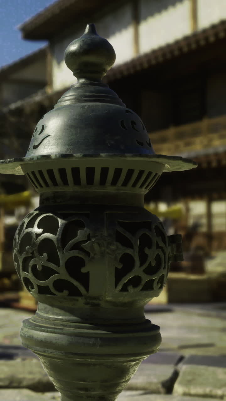 Decorative lamp in a market setting with shops and clear sky