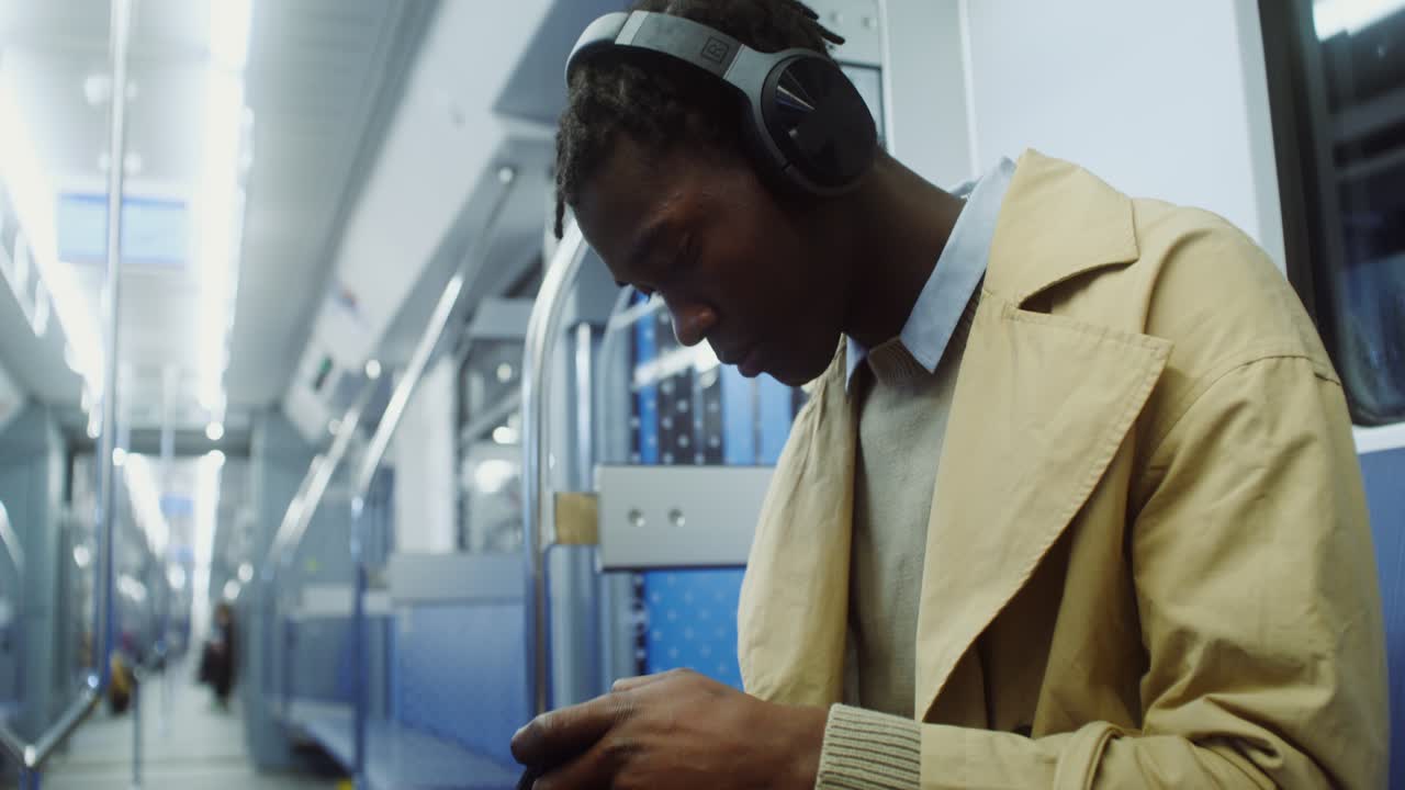 Man using smartphone on subway train