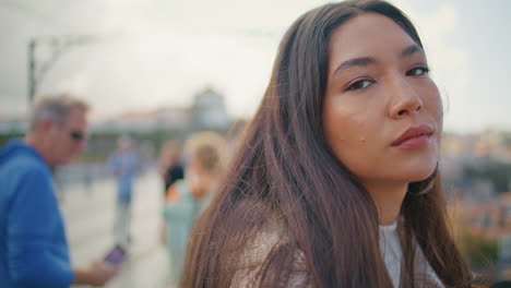 beautiful girl face posing city looking camera portrait. dreaming lady sunny day