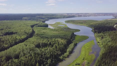 aerial view of a river winding through lush forest