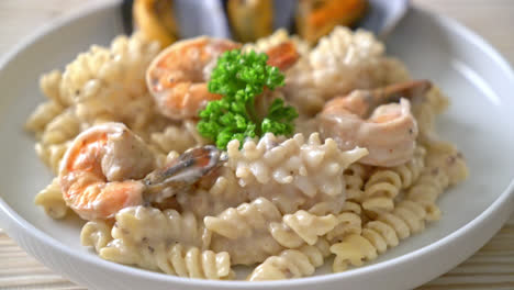 spiral pasta mushroom cream sauce with seafood - italian food style