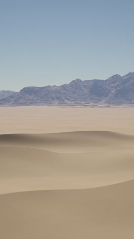 desert landscape with sand dunes and mountains