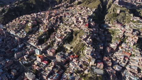 aerial: buildings in la paz bolivia on steep rocky mountain slopes