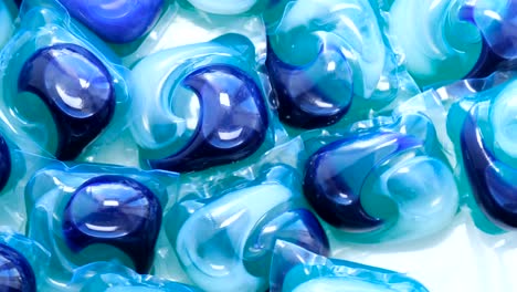 background of colorful capsules with washing powder for washing dishes of the dishwasher