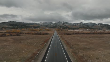 driving on the road through autumn landscape in teton national forest in wyoming, usa