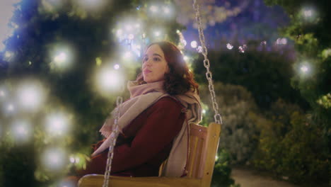 young girl on a swing at the christmas market wide slow motion shot