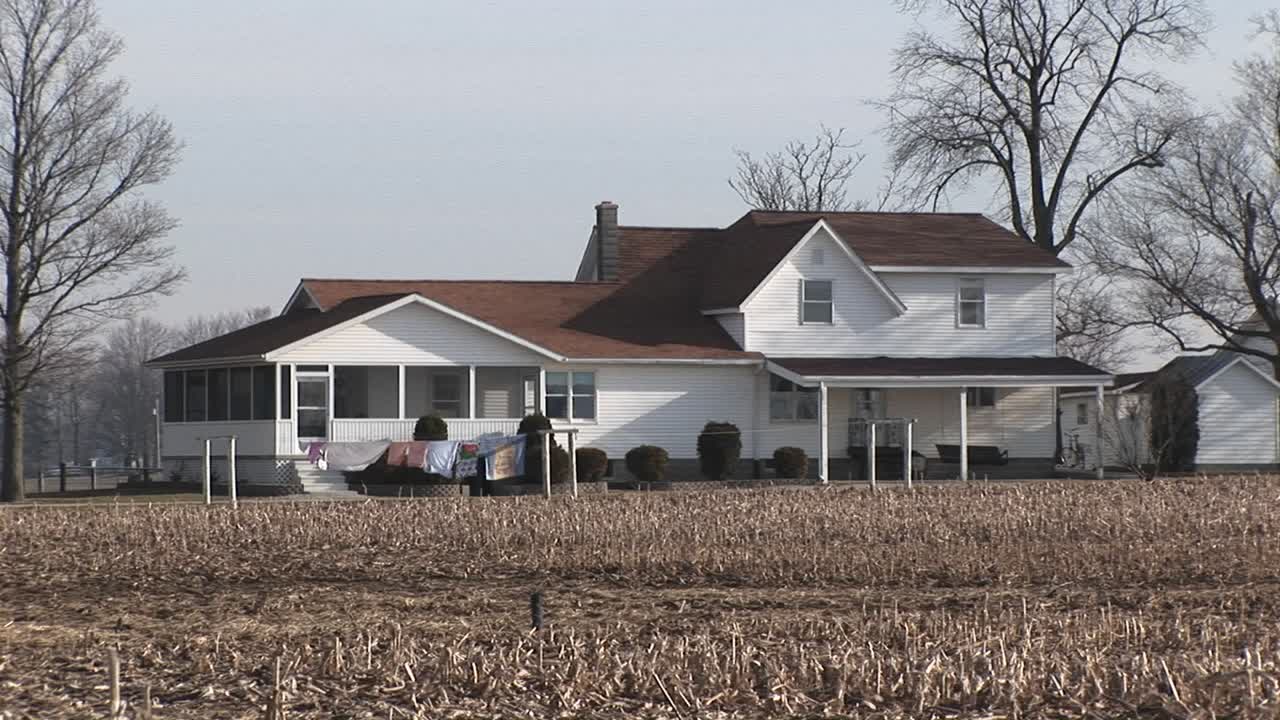 Clothes Hang Outside To Dry Near A Large Rural Homestead