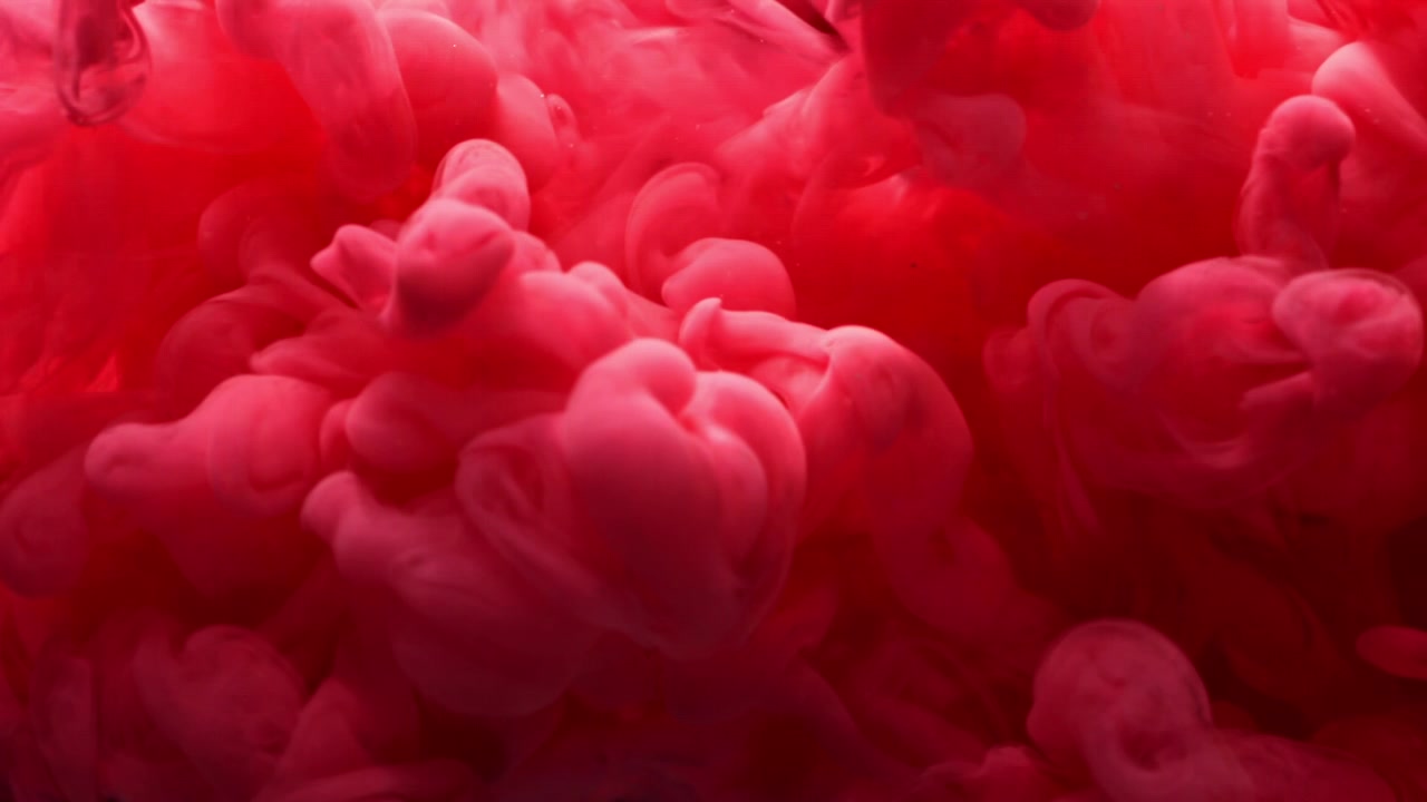 Slow Motion Red Ink Creating Abstract Clouds in Water