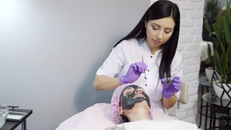 facial treatment of young woman in a cosmetology salon. modern cosmetology.