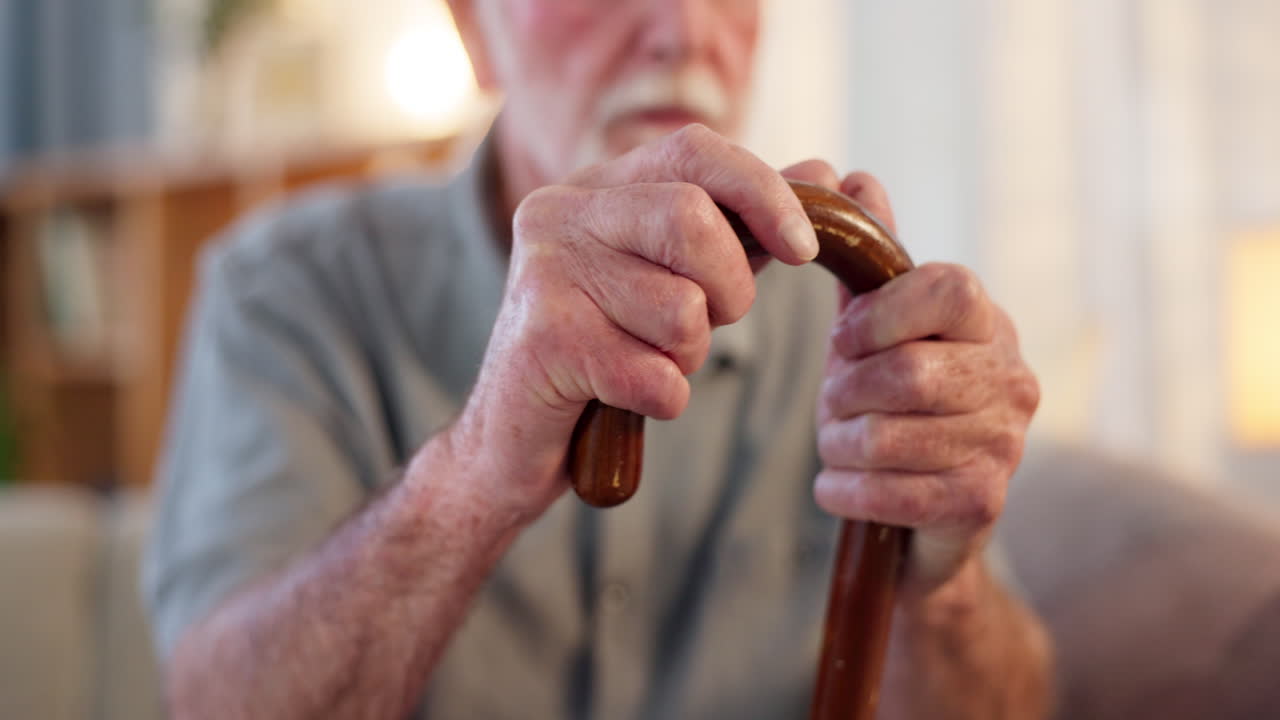 Elderly man holding a walking stick