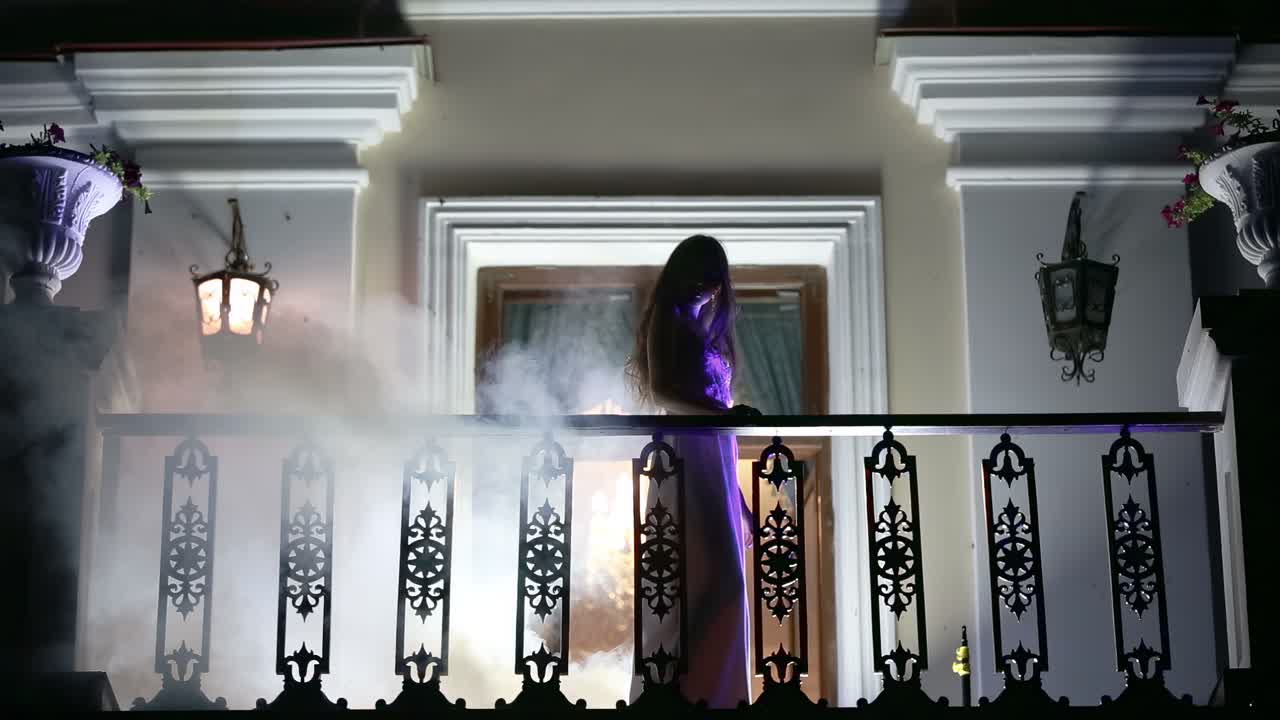 Girl in the smoke on the balcony