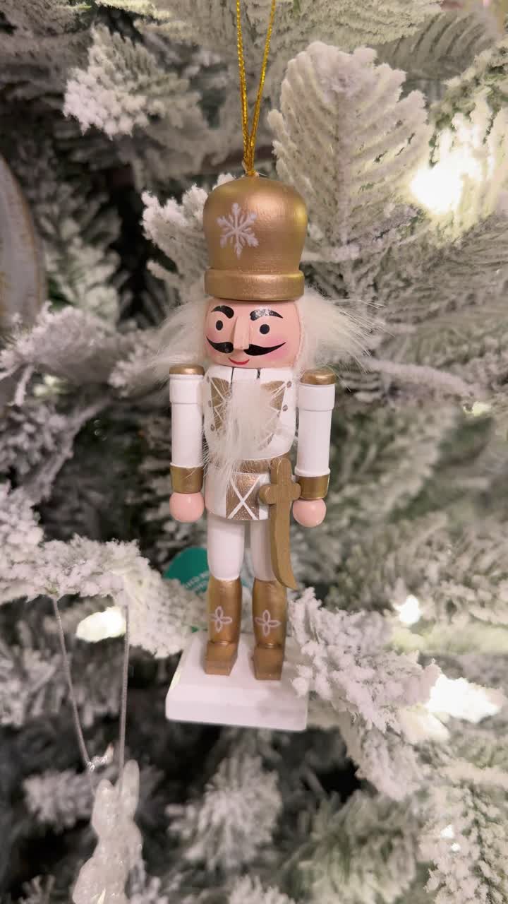 Nutcracker Christmas ornament hanging on tree, wooden decor