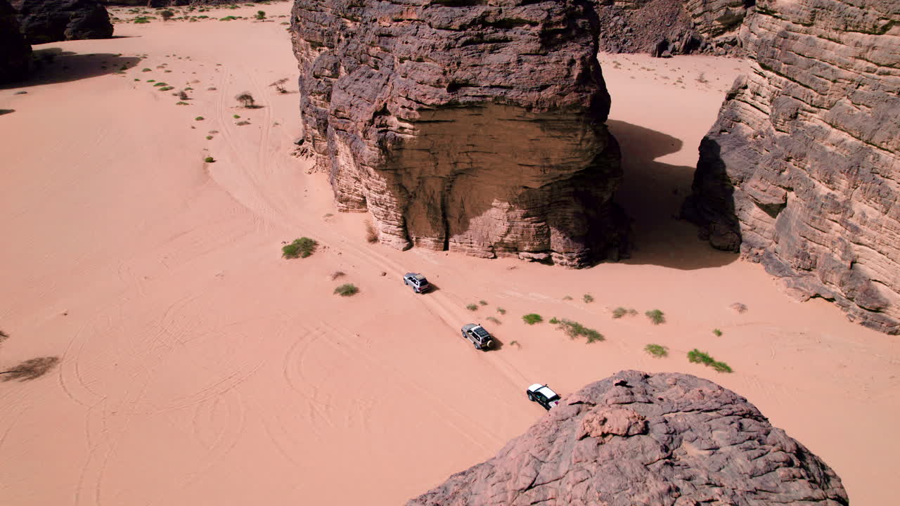 Aerial View Of Cars Driving Across Sahara Desert In Tassili N'Ajjer National Park, Algeria