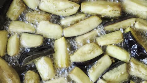 cooking pan fried vegetarian eggplant in vegetable oil