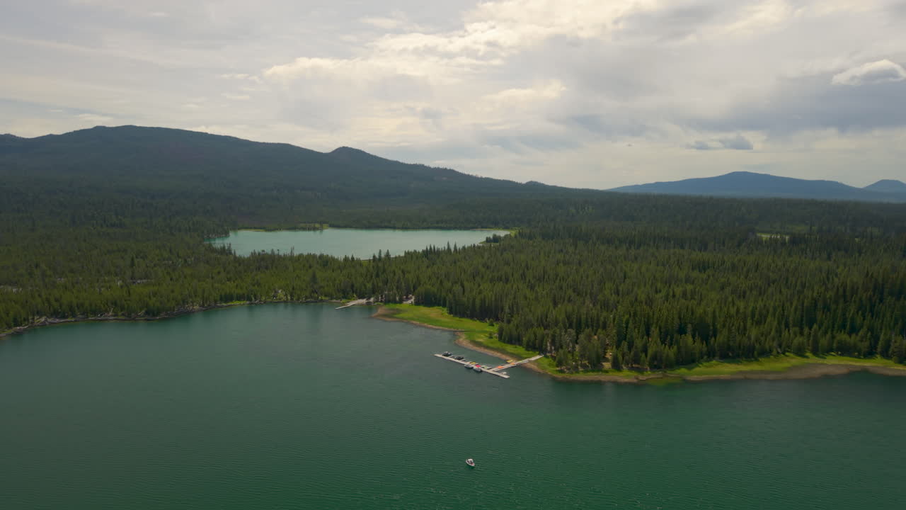 Lava Lake and Little Lava Lake in Central Oregon at the Cascade Lakes Highway. Drone orbit around boat dock.