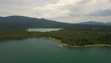 lava lake and little lava lake in central oregon at the cascade lakes highway. drone orbit around boat dock.