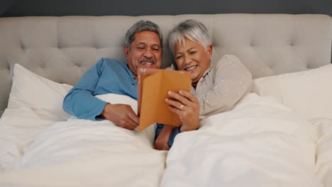 Tablet,-love-and-senior-couple-in-a-bed-laughing