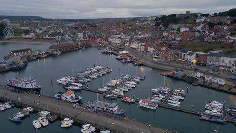 establishing drone shot over scarborough harbour in low light