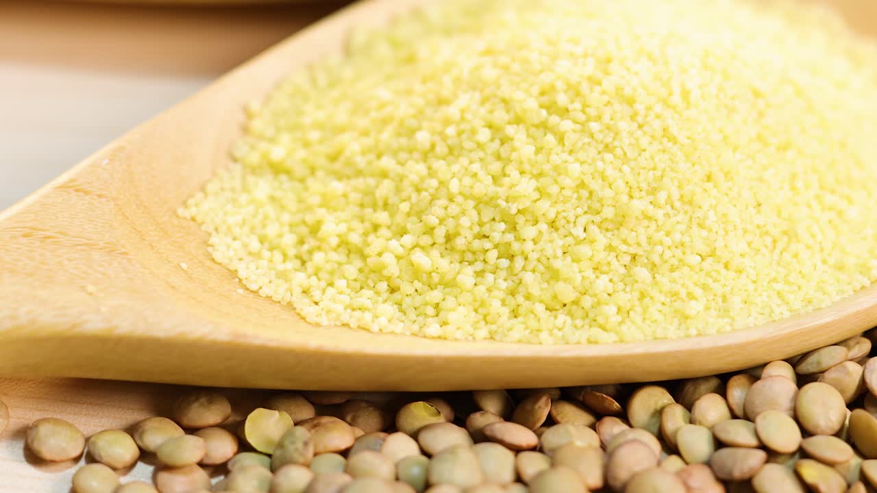 A detailed view of quinoa, couscous, and lentils with smooth camera transitions and natural lighting