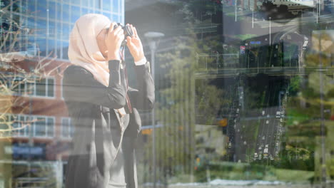 animation of asian woman in hijab with camera over cityscape