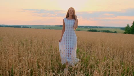 mujer en un campo de trigo al atardecer