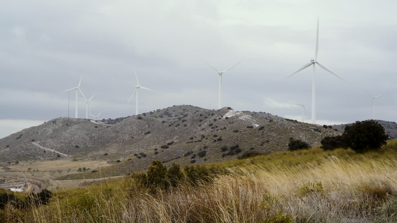 wind turbines generate energy on a cold windy day