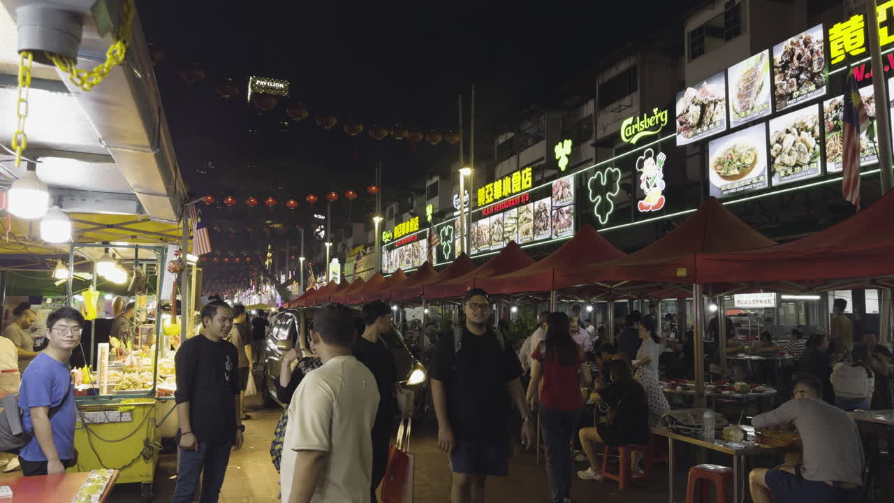 Tourists Walking through Jalan Alor Food Street in Kuala Lumpur, Malaysia. Night