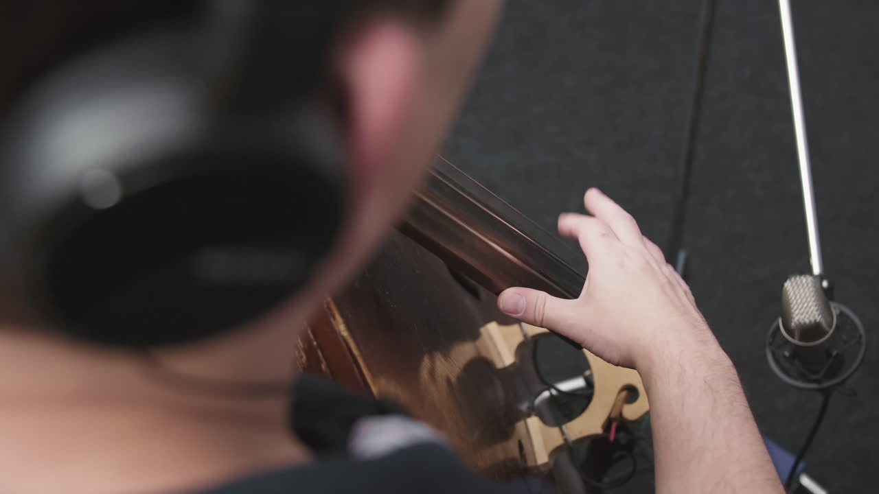 Contrabass Player Recording Instrumental Music In Studio