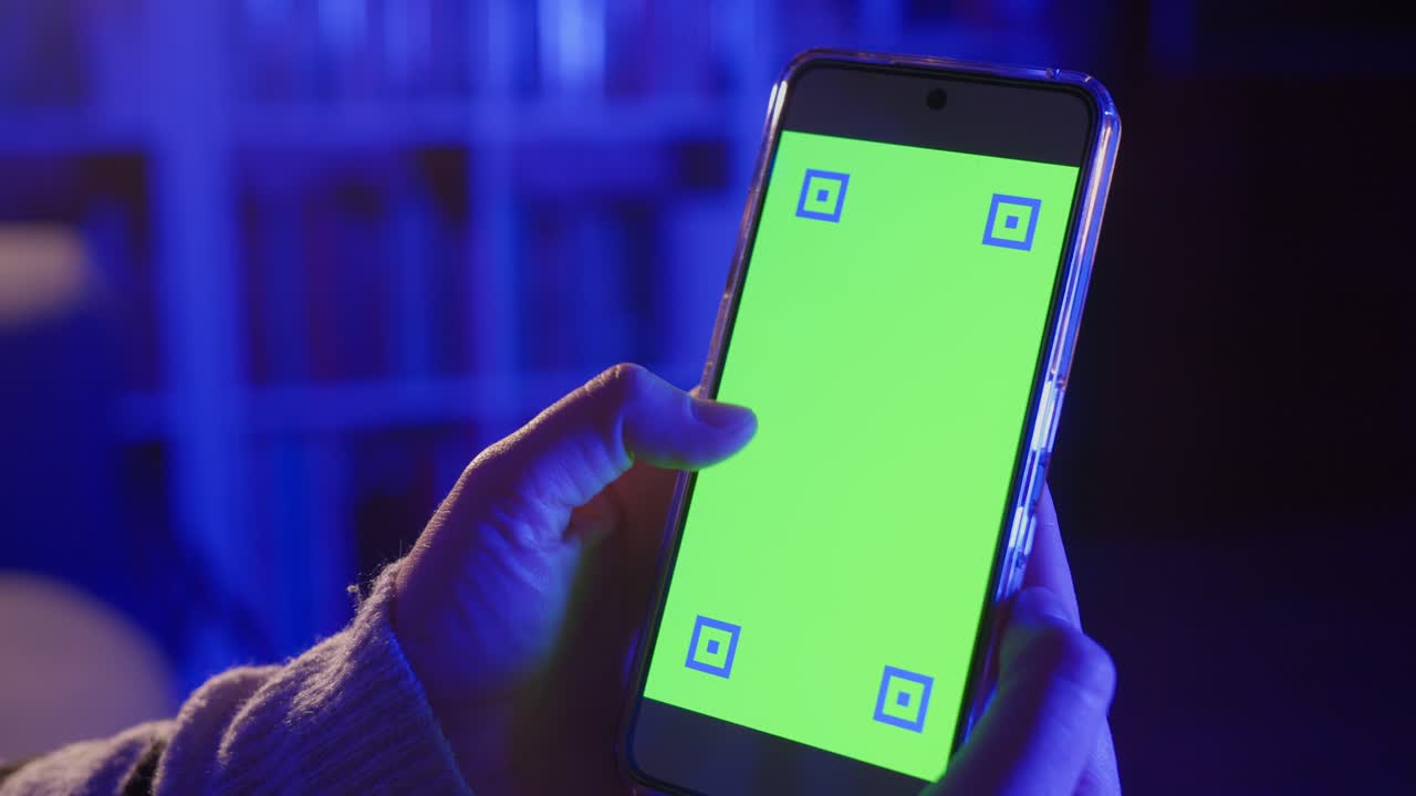 Hand Holding Smartphone with Green Screen for Mockup Display